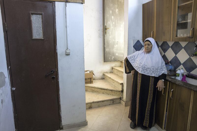 Fahima Shamasneh in the kitchen of her  tiny two room basement home in the East Jerusalem neighborhood of Sheik Jarrah on August 11,2017.

When the Shamasne family first moved into their home  in the 1960s, East Jerusalem was controlled by Jordan and their monthly rent was paid to  Jordanian authorities but since  Israel annexed East Jerusalem in 1967, the Shamasne family has paid their rent to Israel's general custodian in order to remain in the building.
The family claims that their payments were suddenly rejected in 2009 , and they were informed that the property had been claimed by Israeli Jews whose ancestors had lived there decades previously.Although the family has spent years fighting to remain in the home , the Israeli high court has ruled that the family must evacuate the home before August 9. (Photo by Heidi Levine for The National).
