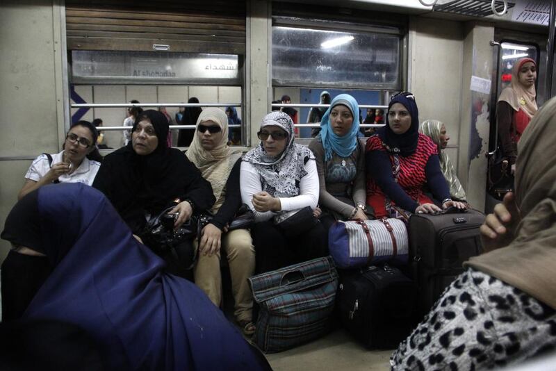 Egyptian women listen to a lecture by a female police officer on how to avoid sexual harassment and how to take care of children, in Al Shohadaa metro station.