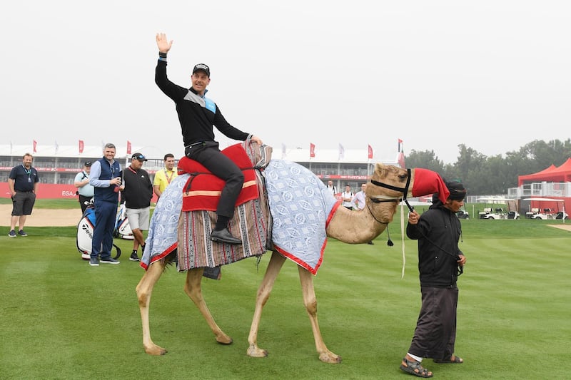 Henrik Stenson rides a camel as part of a photoshoot ahead of the Abu Dhabi HSBC Championship. Ross Kinnaird / Getty Images