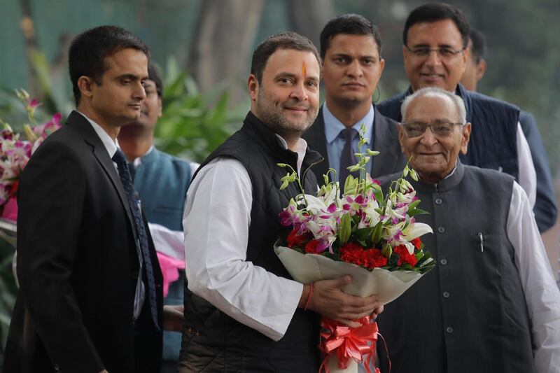 Senior Congress party leaders welcome their party vice president Rahul Gandhi , second left, with flowers as he arrives to file his nomination papers at party headquarters, in New Delhi, India, Monday, Dec. 4, 2017. Gandhi, the scion of India's Nehru-Gandhi political dynasty, has submitted nomination papers to succeed his mother as president of the main opposition Congress party that governed the country for decades. (AP Photo/Manish Swarup)