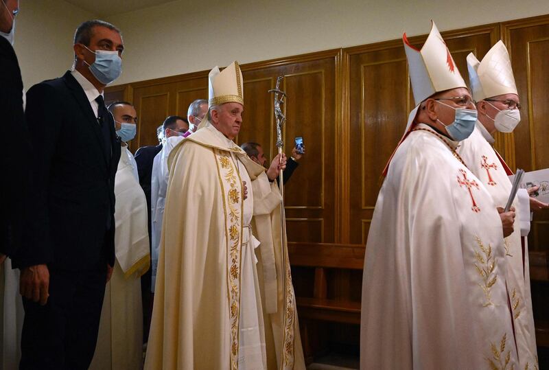 Pope Francis arrives to lead mass at Baghdad's Saint Joseph Cathedral. AFP