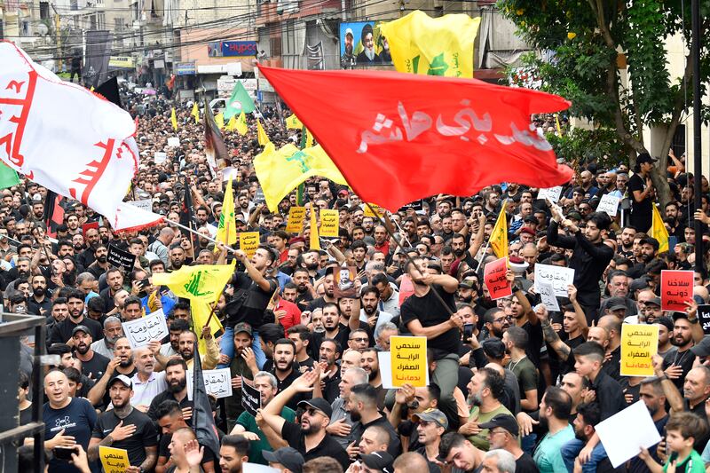 Hezbollah supporters shout religious slogans during the funeral of Hezbollah fighter Ahmed Qassas in a southern suburb of Beirut. EPA 