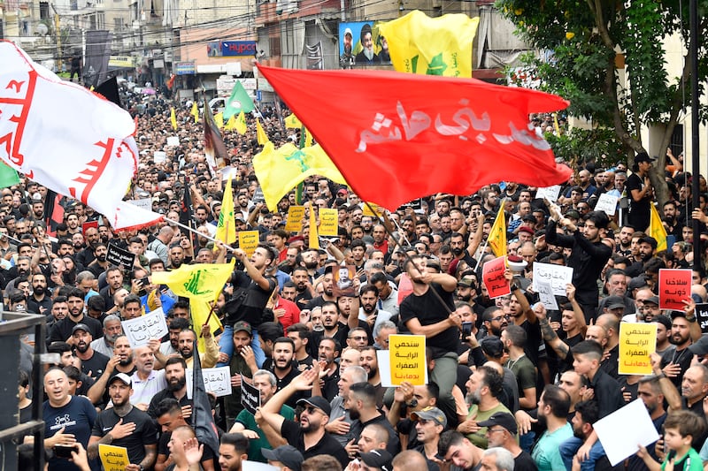 Hezbollah supporters shout religious slogans during the funeral of Hezbollah fighter Ahmed Qassas in a southern suburb of Beirut. EPA 
