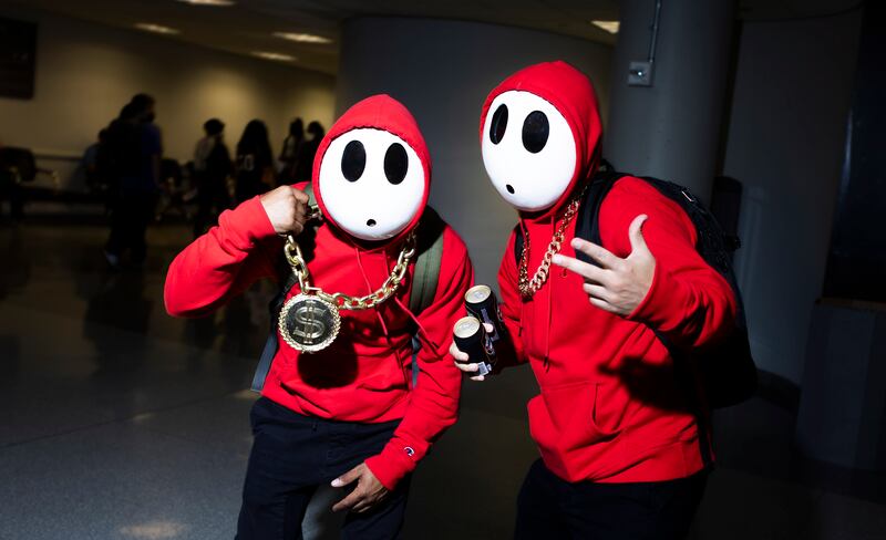 Tommy Perea, left, and Brian Talledo, right, of New Jersey, cosplay as ShyGuys from the Mario Bros video game franchise at New York Comic Con. Justin Lane / EPA