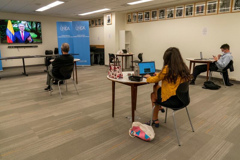Members of the media observe social distancing as they listen to Colombian President Ivan Duque Marquez deliver an address via video link in the United Nations Correspondents Association office at United Nations headquarters. AP Photo