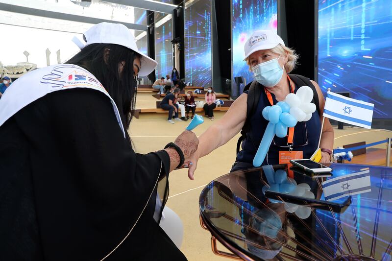 A henna artist decorates a visitor's hand during the Israel day celebration.