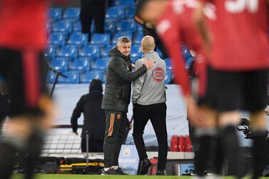 Manchester United's Norwegian manager Ole Gunnar Solskjaer (L) and Manchester City's Spanish manager Pep Guardiola (R) interact after the final whistle of the English Premier League football match between Manchester City and Manchester United at the Etihad Stadium in Manchester, north west England, on March 7, 2021. RESTRICTED TO EDITORIAL USE. No use with unauthorized audio, video, data, fixture lists, club/league logos or 'live' services. Online in-match use limited to 120 images. An additional 40 images may be used in extra time. No video emulation. Social media in-match use limited to 120 images. An additional 40 images may be used in extra time. No use in betting publications, games or single club/league/player publications. / AFP / POOL / PETER POWELL / RESTRICTED TO EDITORIAL USE. No use with unauthorized audio, video, data, fixture lists, club/league logos or 'live' services. Online in-match use limited to 120 images. An additional 40 images may be used in extra time. No video emulation. Social media in-match use limited to 120 images. An additional 40 images may be used in extra time. No use in betting publications, games or single club/league/player publications.