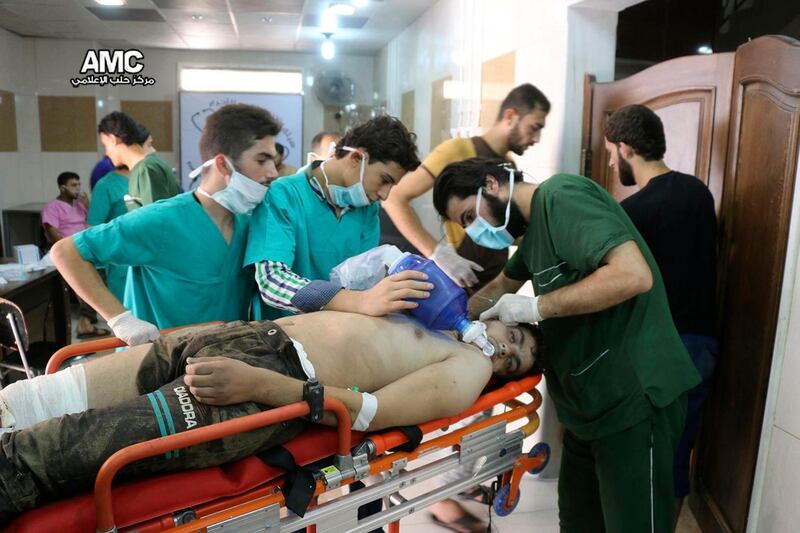 FILE - In this Sept. 6, 2016, file photo, provided by the Syrian anti-government activist group Aleppo Media Center (AMC), shows medical staff treating a man suffering from breathing difficulties inside a hospital in Aleppo, Syria after a chemical attack. Rival U.S. and Russian resolutions to extend the mandate of experts trying to determine who was responsible for chemical attacks in Syria were defeated Thursday, Nov. 16, 2017, at a United Nations Security Council meeting. (Aleppo Media Center via AP, File)