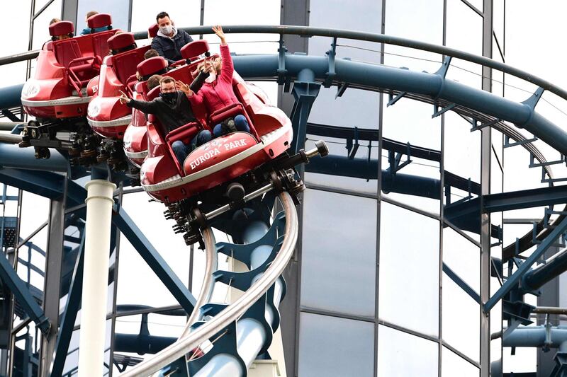 Visitors ride a rollercoaster at Europa Park in Rust, western Germany, on Friday, on the theme park's reopening day after the relaxation of Covid-19 restrictions. AFP