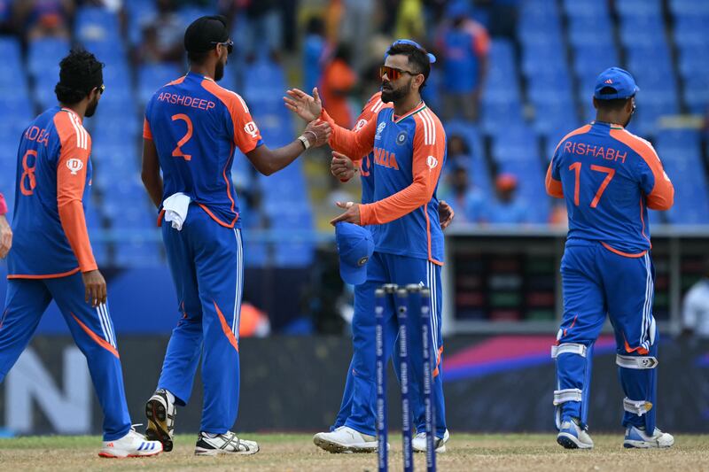 India's Virat Kohli, centre, celebrates with Arshdeep Singh after winning the ICC men's Twenty20 World Cup 2024 Super Eight match against Bangladesh at Sir Vivian Richards Stadium. AFP