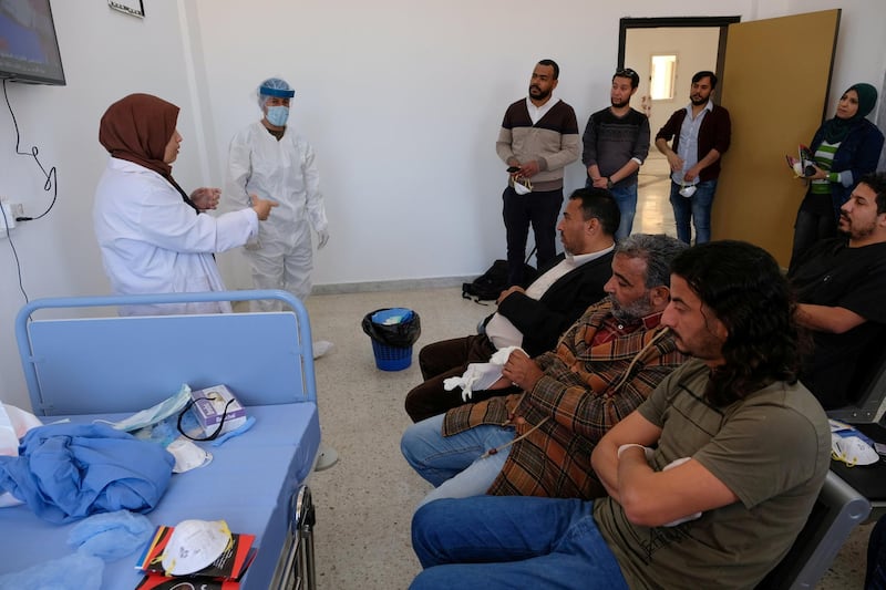 A doctor talks to nursing staff about sterilisation and handling suspected cases of coronavirus at a medical clinic in Benghazi, Libya. Reuters