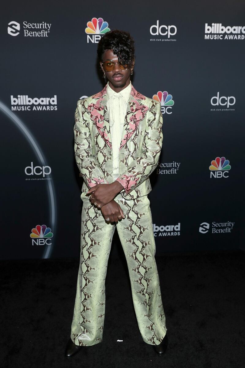 Lil Nas X attends the 2020 Billboard Music Awards in a Gucci snakeskin suit. Reuters
