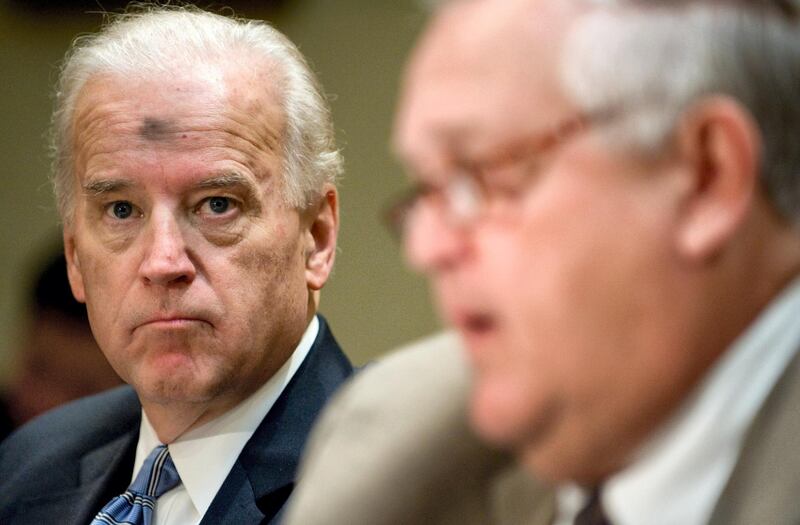 US Vice President Joe Biden listens as Chairman of the Transparency and Accountability Board, Earl Devaney (R) speaks during a Recovery Plan Implementation meeting in the Roosevelt Room of the White House in Washington, DC on February 25, 2009. (Editor note,the mark on Biden's head is from Christian worship services ashes from the first day of Lent).  AFP PHOTO / Saul LOEB (Photo by SAUL LOEB / AFP)