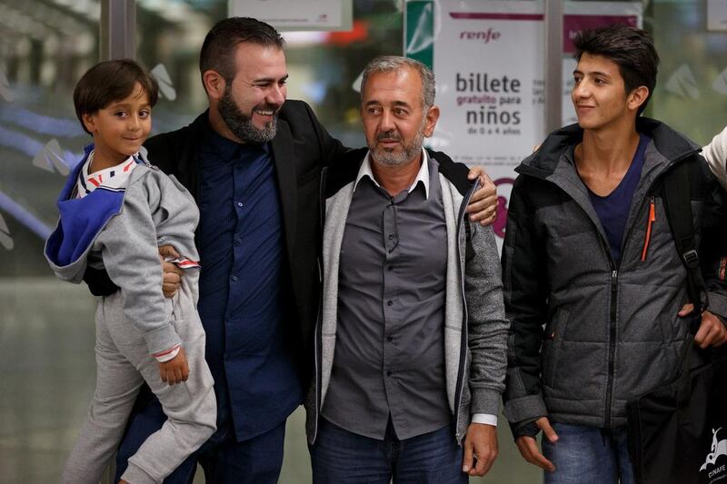 Syrian refugee Osama Abdul Mohsen, second right, with his sons Mohammed, 18, and Zaid, 7, after arriving Atocha train station in Madrid, Spain. Pablo Blazquez Dominguez / Getty Images