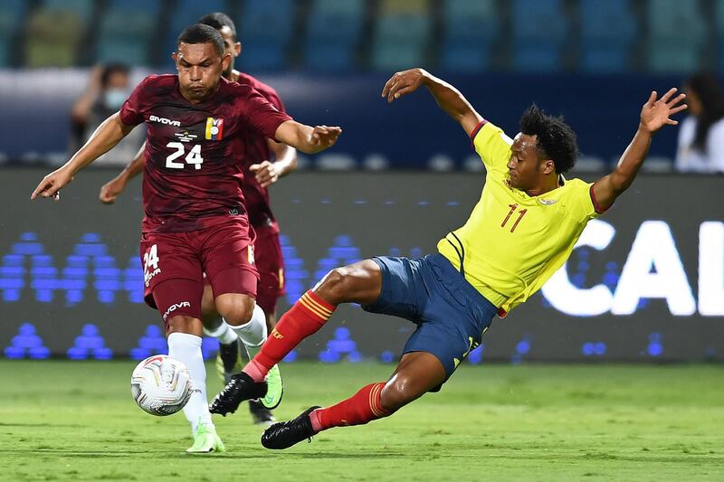 Venezuela's Bernaldo Manzano, left, and Colombia's Juan Cuadrado vie for the ball during their Copa America group match at the Olympic Stadium in Goiania, Brazil. AFP