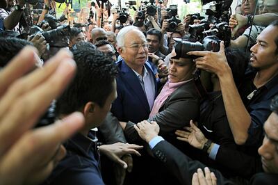 Najib Razak, Malaysia's former prime minister, center, is surrounded by members of the media as he arrives at the Malaysian Anti-Corruption Commission's headquarters in Putrajaya, Malaysia, on Tuesday, May 22, 2018. Najib is at the center of investigations looking into the Malaysian state investment fund known as 1MDB and whether it was used for embezzlement or money laundering. Photographer: Rahman Roslan/Bloomberg