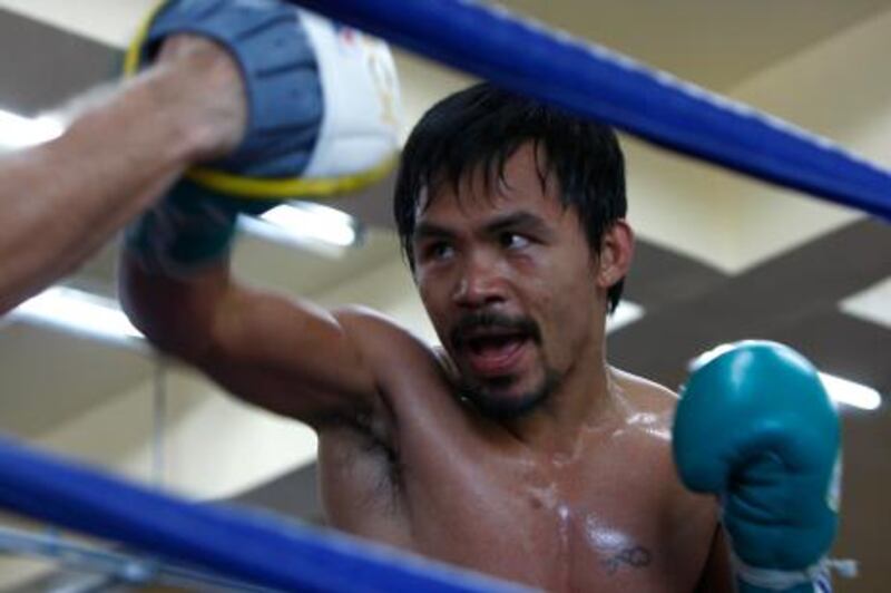 Baguio, Philippines, March 19, 2011, (right)  Manny Pacquiao with (left and partiacally seen) Freddie Roach during training. Pacquiao will fight Shane Mosely  May 7th in Las Vegas Nevada. Pacquiao and his training team are in Baguio Philippines approximately 250km North of Manila.  Mike Young / The National