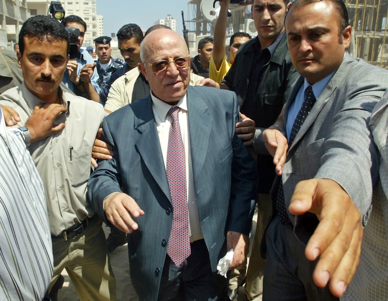 The Palestinian PM is flanked by bodyguards as he arrives to attend weekly cabinet meeting in Gaza city in July 2005. Reuters