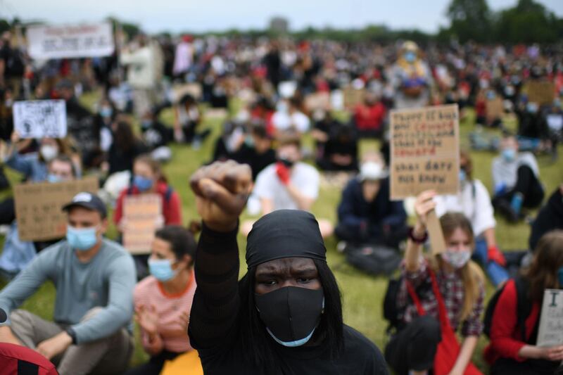 Protestors hold placards during a demonstration in London. AFP