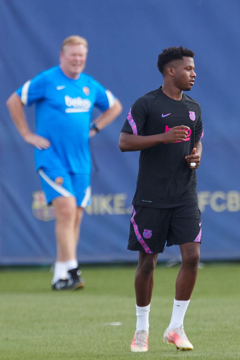 Barcelona's Ansu Fati is watched by manager Ronald Koeman. EPA