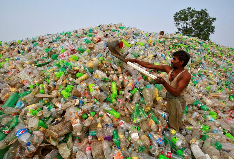 A man makes a heap of plastic bottles at a junkyard on World Environment Day in Chandigarh, India, June 5, 2018. REUTERS/Ajay Verma