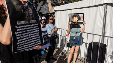 A woman carries a picture of Nika Shakarami at a rally in Melbourne marking the anniversary of Mahsa Amini's death in custody of Iran's morality police. EPA
