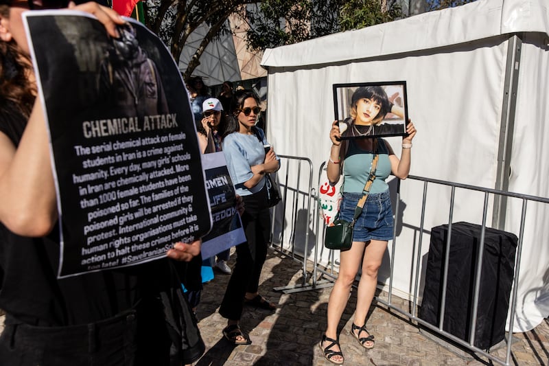 A protester in Federation Square, Melbourne, holds a photo of Iranian girl Nika Shakarami, who was found dead after going missing during protests in Tehran in 2022. EPA