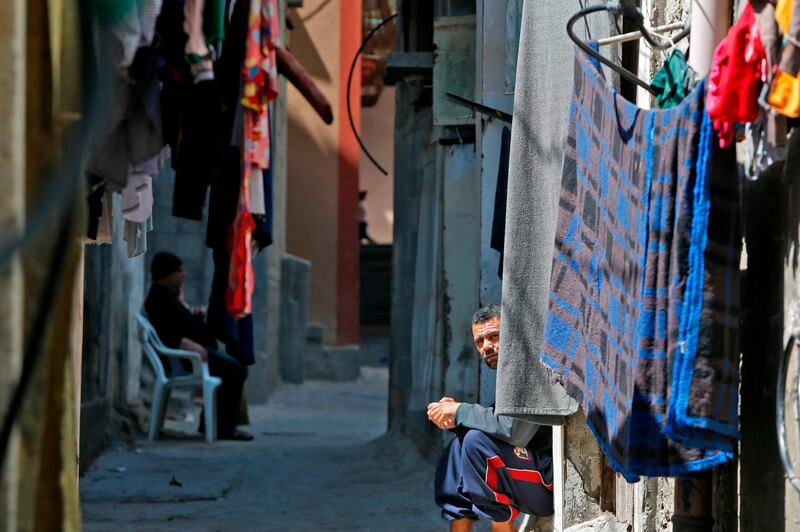 A Palestinian sits next to his home in the Gaza Strip's al-Shati refugee camp. AFP