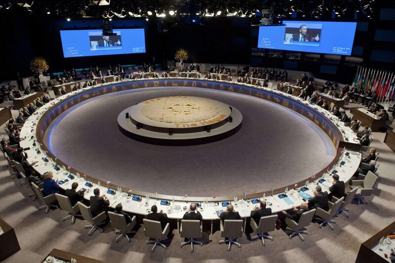 US President Barack Obama, seen here on the screens, addresses the closing session of the Nuclear Security Summit in The Hague on March 25, 2014. Thirty-five countries committed to bolstering nuclear security and preventing dangerous materials from falling into the hands of terrorists. Saul Loeb/AFP