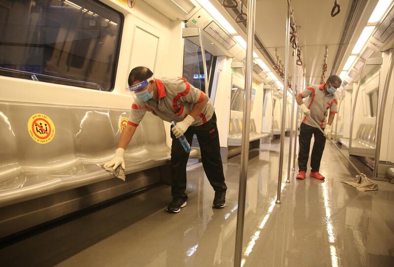 Indian metro workers sanitise a coach as a precautionary measure in New Delhi, India.  EPA