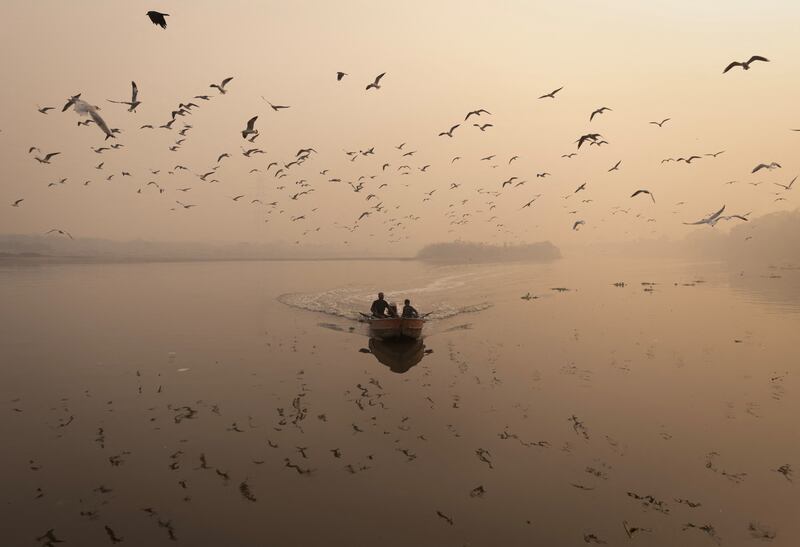 A man sails his boat amid heavy smog in the Yamuna River in the old quarters of Delhi, India. Reuters