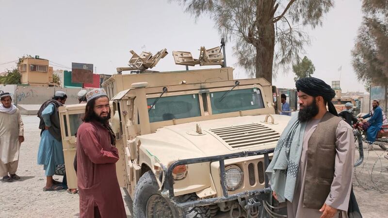 Afghan Taliban patrol in a Humvee that was captured from Afghan security forces after the militants took control of Spin Boldak on the border with Pakistan. EPA