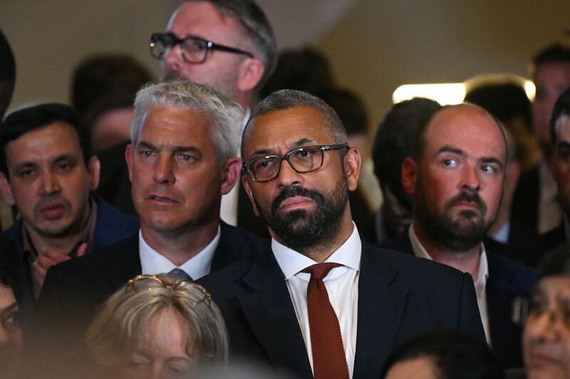 UK Environment, Food and Rural Affairs Secretary Steve Barclay and Home Secretary James Cleverly listen to Mr Sunak's speech. AFP