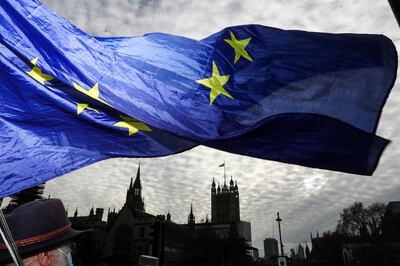 Anti-Brexit campaigners wave the European Union (EU) flag outside the Houses of Parliament in London, U.K., on Wednesday, Dec. 9, 2020. U.K. Prime Minister Boris Johnson travels to Brussels for dinner with Ursula von der Leyen on Wednesday as both sides seek to save Brexit trade negotiations. Photographer: Simon Dawson/Bloomberg