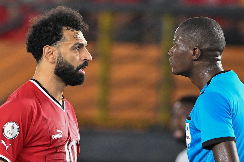 Mohamed Salah speaks with Gabonese referee Pierre Atcho. AFP