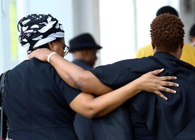 Visitors embrace as they leave Singapore Casket, the funeral parlour where the body of the late former Zimbabwe's President Robert Mugabe is being held in Singapore, September 8, 2019. REUTERS/Feline Lim