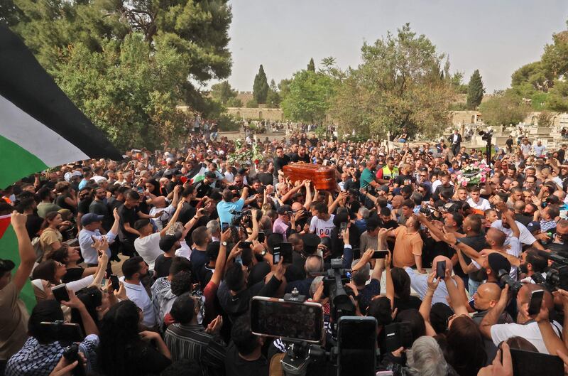 Mourners carry the coffin to the Mount Zion Cemetery. AFP