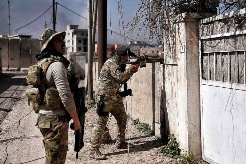 Iraqi troops patrol areas retaken from ISIS in western Mosul on March 9, 2017. AFP