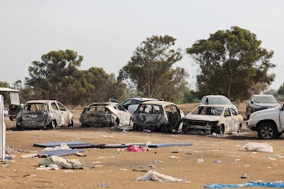 Burnt vehicles are left behind at the site of the weekend attack on the Supernova desert music Festival by Palestinian militants near Kibbutz Reim in the Negev desert in southern Israel on October 10. AFP
