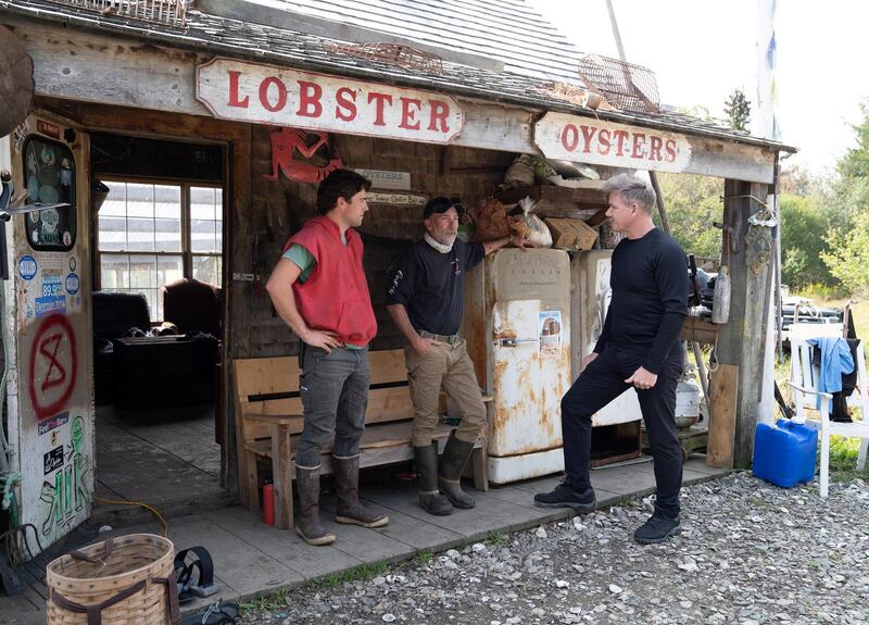 Maine - Gordon Ramsay (R) meets with father and son duo Adam (center) and Zeb (L) to harvest clams and oysters. (Credit: National Geographic/Justin Mandel)