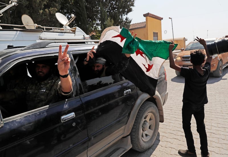 Members of Turkey-backed Syrian National Army (former FSA) flash the V-sign as they drive back to Turkey after they went in for some time on inspection according to the Turkish police entourage in the same area at the border between Turkey and Syria, in Akcakale, Sanliurfa province, southeastern Turkey. Turkish President Recep Tayyip Erdogan has long threatened to send troops into northeastern Syria to clear the border region of Syrian Kurdish fighters whom Turkey considers a serious security threat. AP Photo