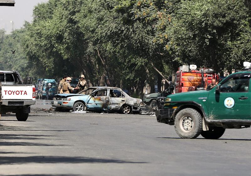 Members of Afghan security forces inspect the site of the blast. Reuters