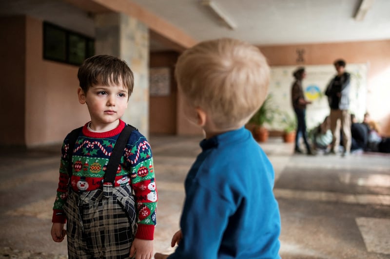 Children look on as people fleeing Russia's invasion of Ukraine shelter in a school, in Drohobych, Ukraine. Reuters