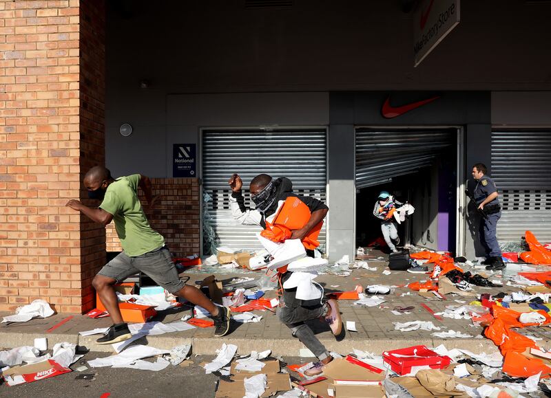 Looters empty a store of goods in the Springfield Value Centre during a protest in Durban, South Africa.  Former South Africa President Zuma was arrested on July 7 and sentenced to 15 months in prison for contempt of court.  Protests by his supporters included shops being looted, burned cars and the blocking of city streets.