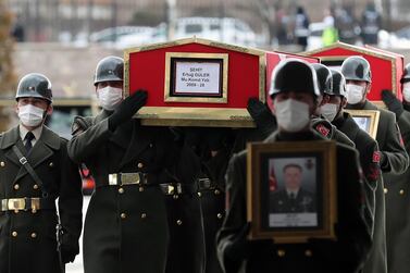 The coffin and image of Turkish Lt. Ertug Guler are carried during the funeral of three Turkish military personnel killed in action at Ankara's Ahmet Hamdi Akseki Mosque in Ankara on February 12, 2021. AFP