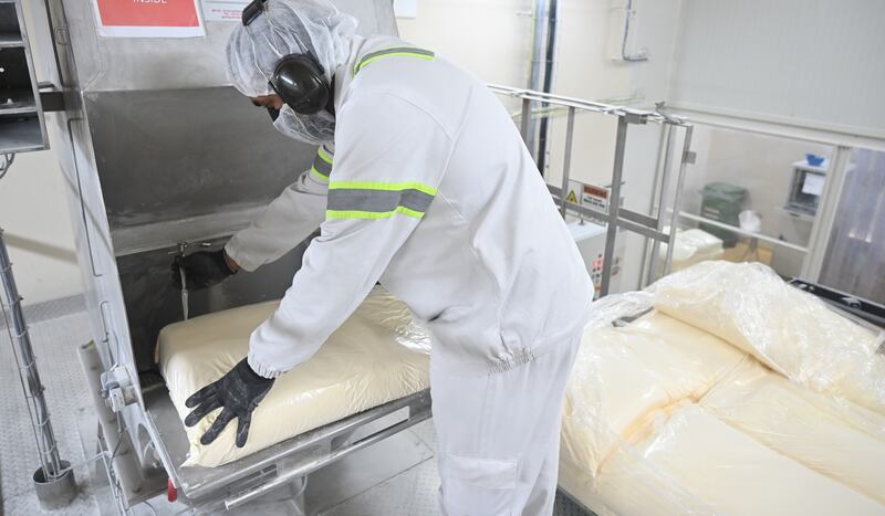 A worker at the KitKat factory in Dubai prepares the ingredients for the chocolate. 