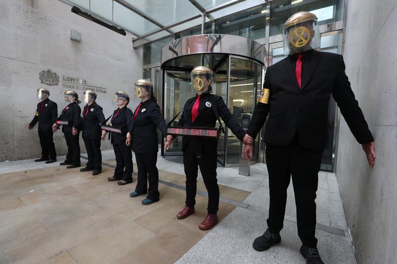 Demonstrators glue their hands to the London stock exchange during the Extinction Rebellion protest in London, Britain April 25, 2019. REUTERS/Simon Dawson
