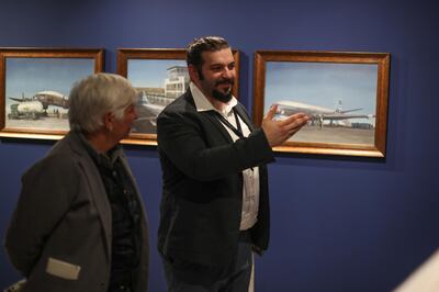 Ahmed Muqeem presenting his works to visitors at the 'In My Dream I Was in Kuwait' exhibition in Venice. Courtesy of ASCC