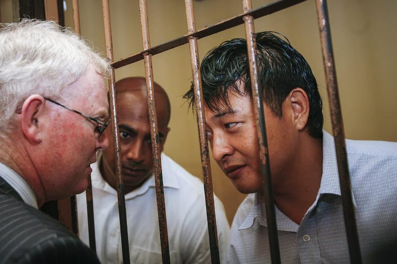 A file picture of Australian Andrew Chan, right, and Myuran Sukumaran, centre, talking to their lawyer before their final appeal against their death sentence at Denpasar District Court in Bali, Indonesia on October 8, 2010.  Made Nagi/EPA