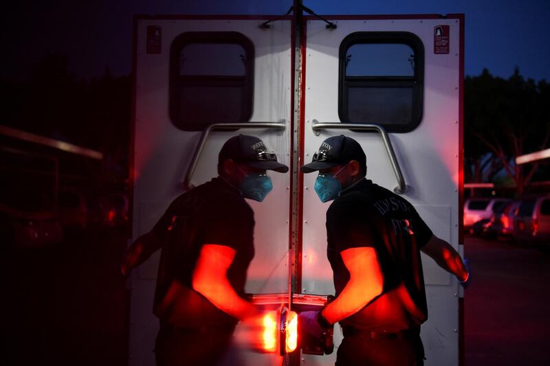 A firefighter tends to a non-COVID-19 patient while wearing protective equipment, against the spread of the coronavirus disease (COVID-19), in Houston, Texas, U.S. REUTERS